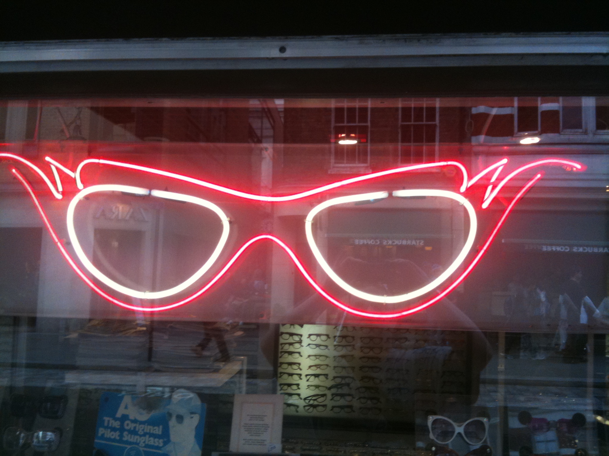 glasses are sitting on display behind a window