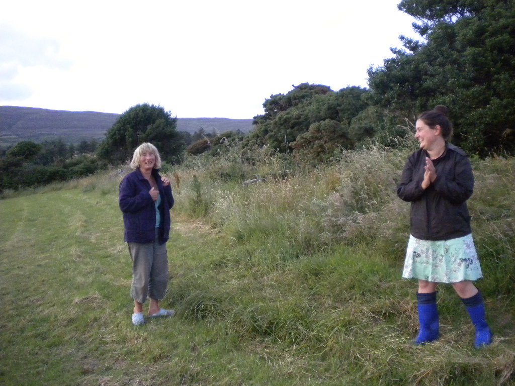 a couple of women that are standing in the grass