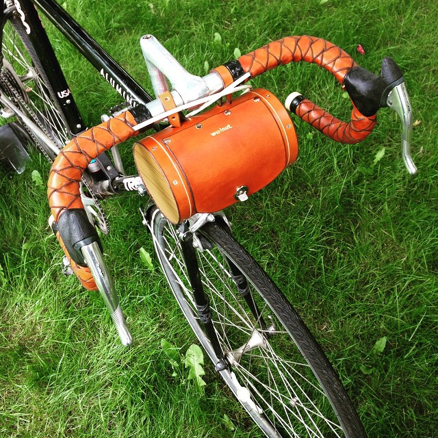 a bike with a bag strapped to the front wheel
