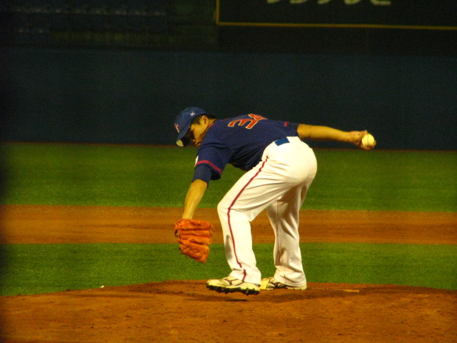 the pitcher prepares to throw the ball during a baseball game