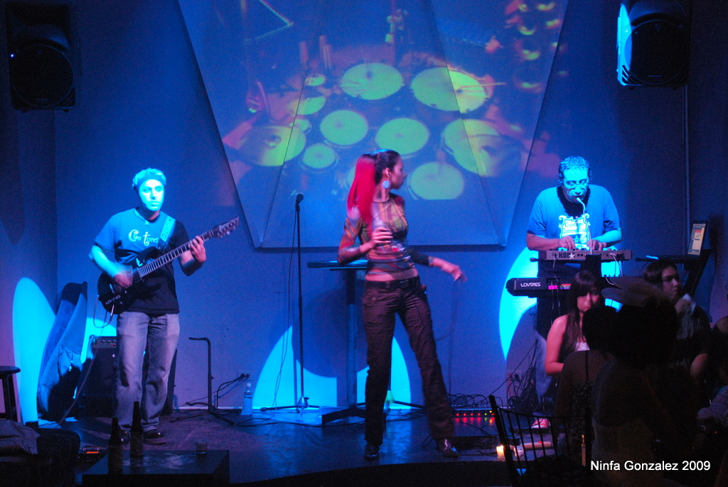 group of young people playing on instruments in front of projection display