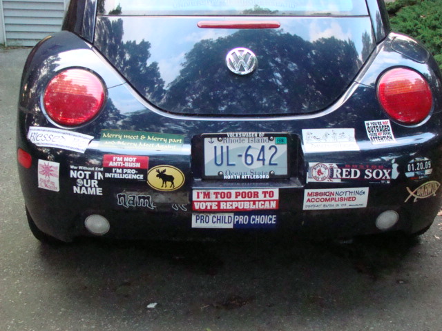 a car with license plates and a bunch of stickers on it