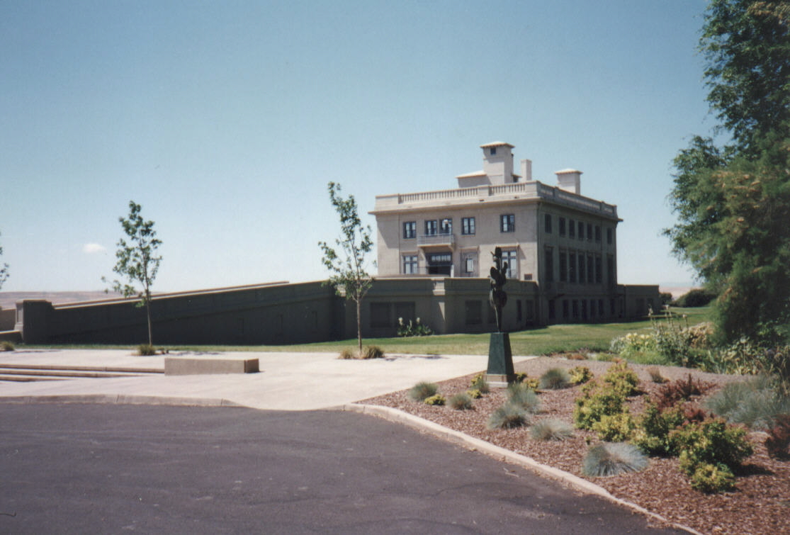 large home with multiple chimneys and courtyard in residential area