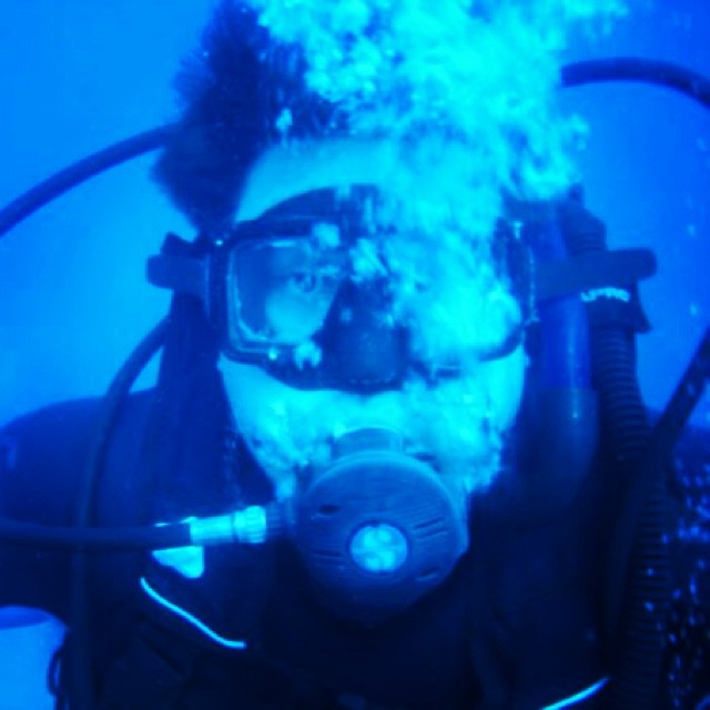 a man wearing a christmas hat with a scuba goggles on