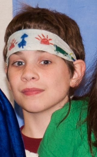 a child poses for the camera wearing a visor