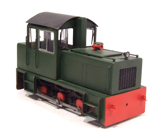a green train sitting on a white background