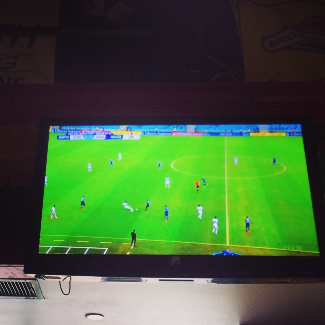 a television screen showing a soccer match on the field
