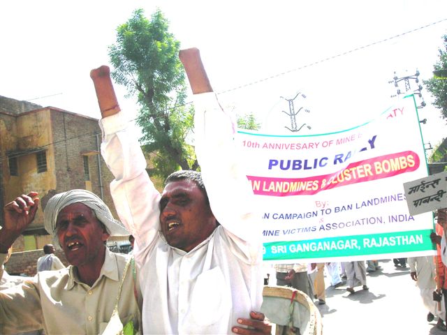 two men holding up signs next to a road