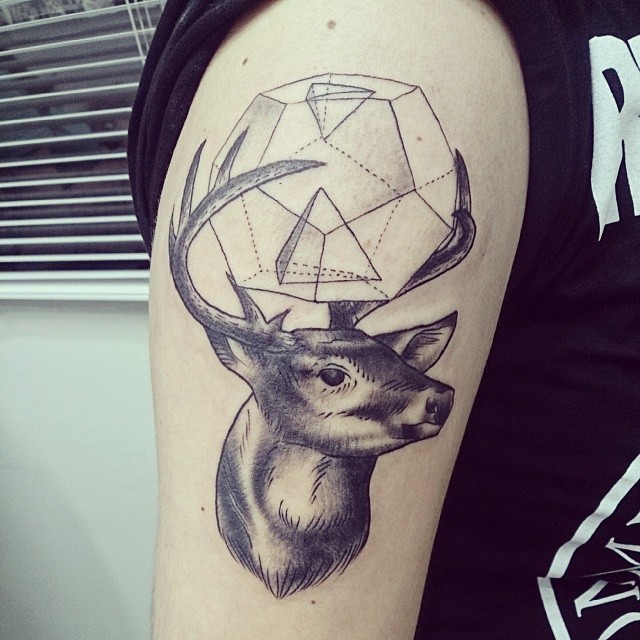 a tattoo with a deer's head in the middle