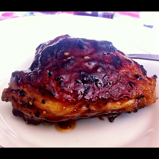 a plate of barbecued meat sitting on a table