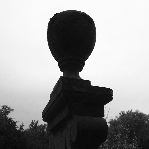 black and white po of a statue with trees in background