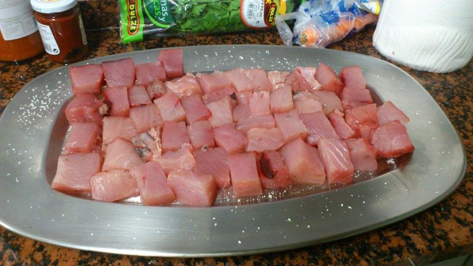 some meat on a serving tray on a kitchen counter