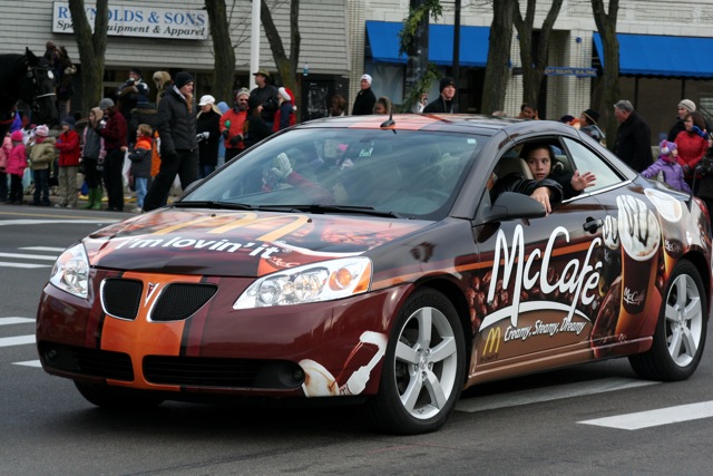 a car that has a bunch of people standing in the back