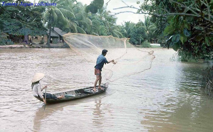 a man is fishing on his small boat