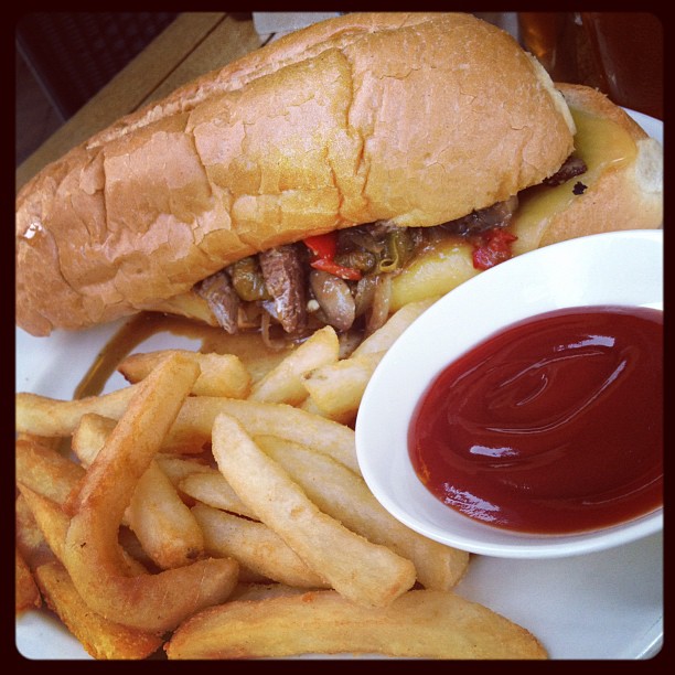 a sandwich and french fries on a white plate