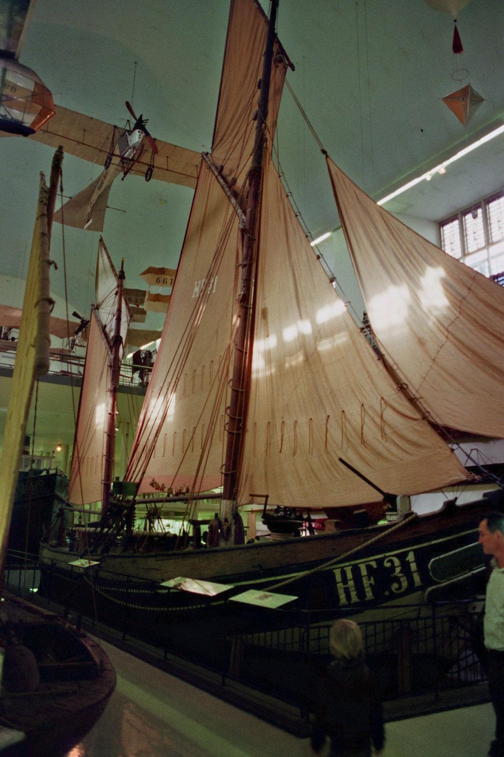 a tall ship inside of a building on display