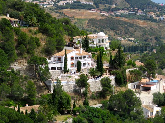 an estate that is surrounded by trees on a hillside