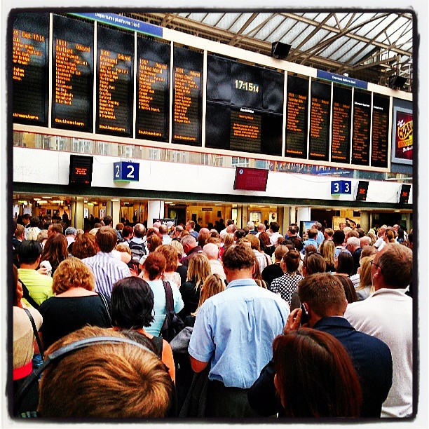 an outdoor space filled with people looking at electronic displays