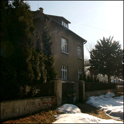 the house and trees are outside in winter time
