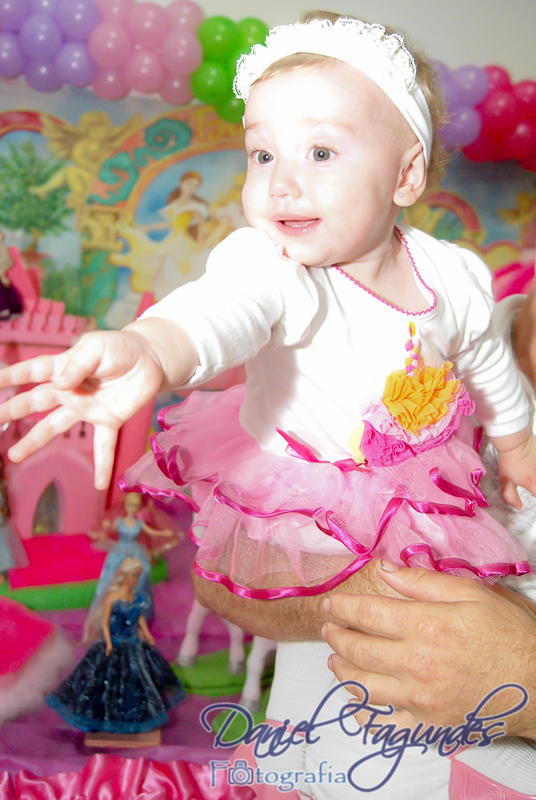 a baby wearing a princess outfit is being held by a man