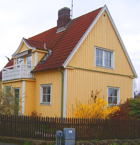 a house with red tiled roofs and fence
