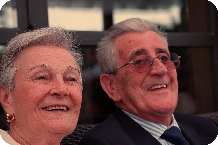 an older man and an younger woman sit together