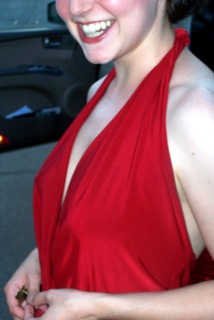 a close up of a person wearing a dress and smiling
