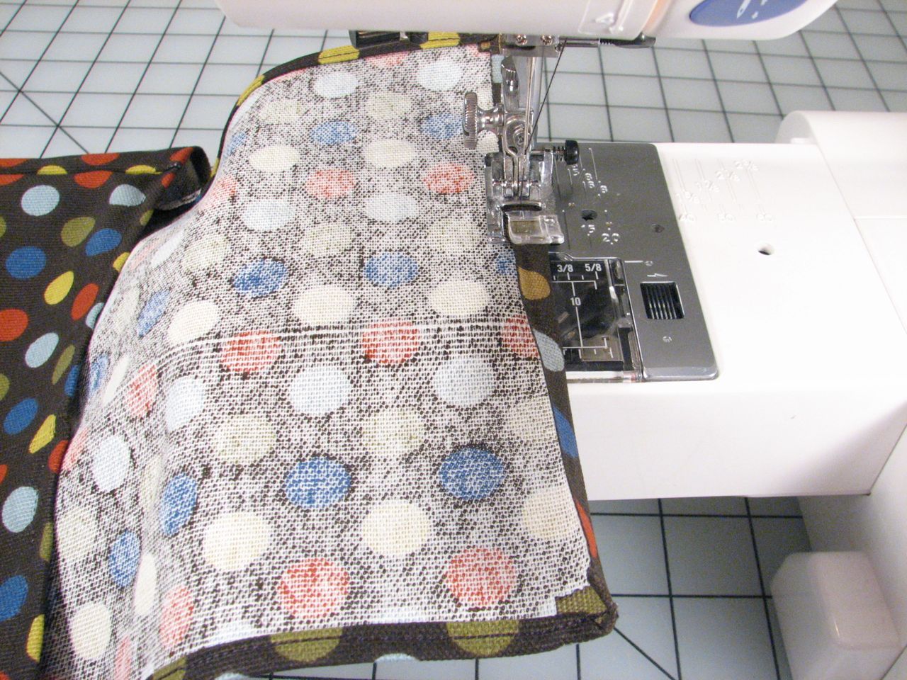 a quilt and a sewing machine that have various things on it