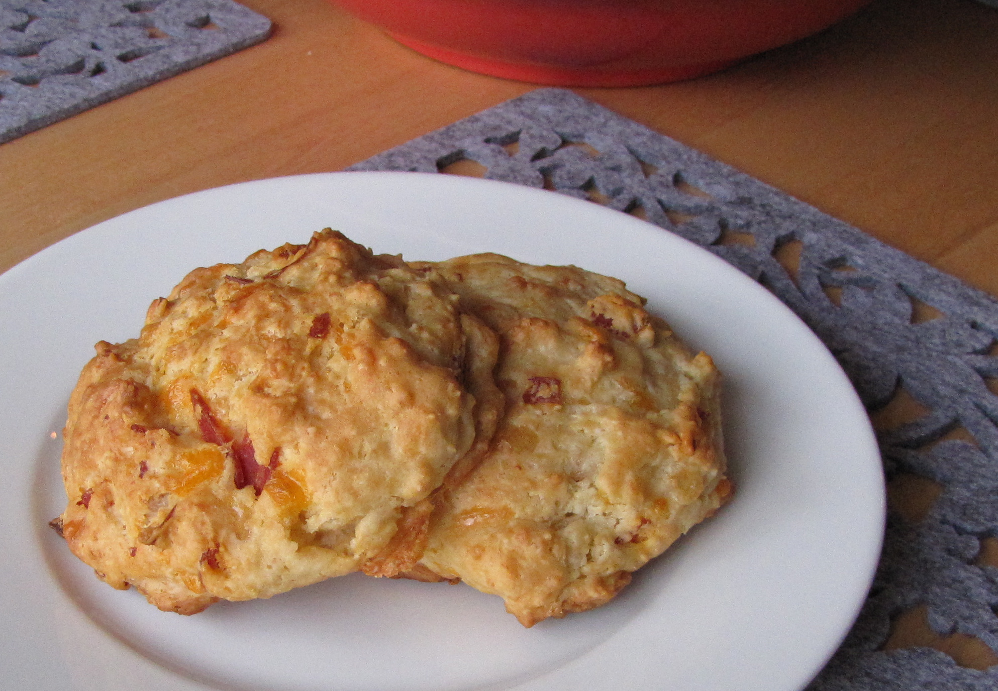 two biscuits on a plate next to a pink plate