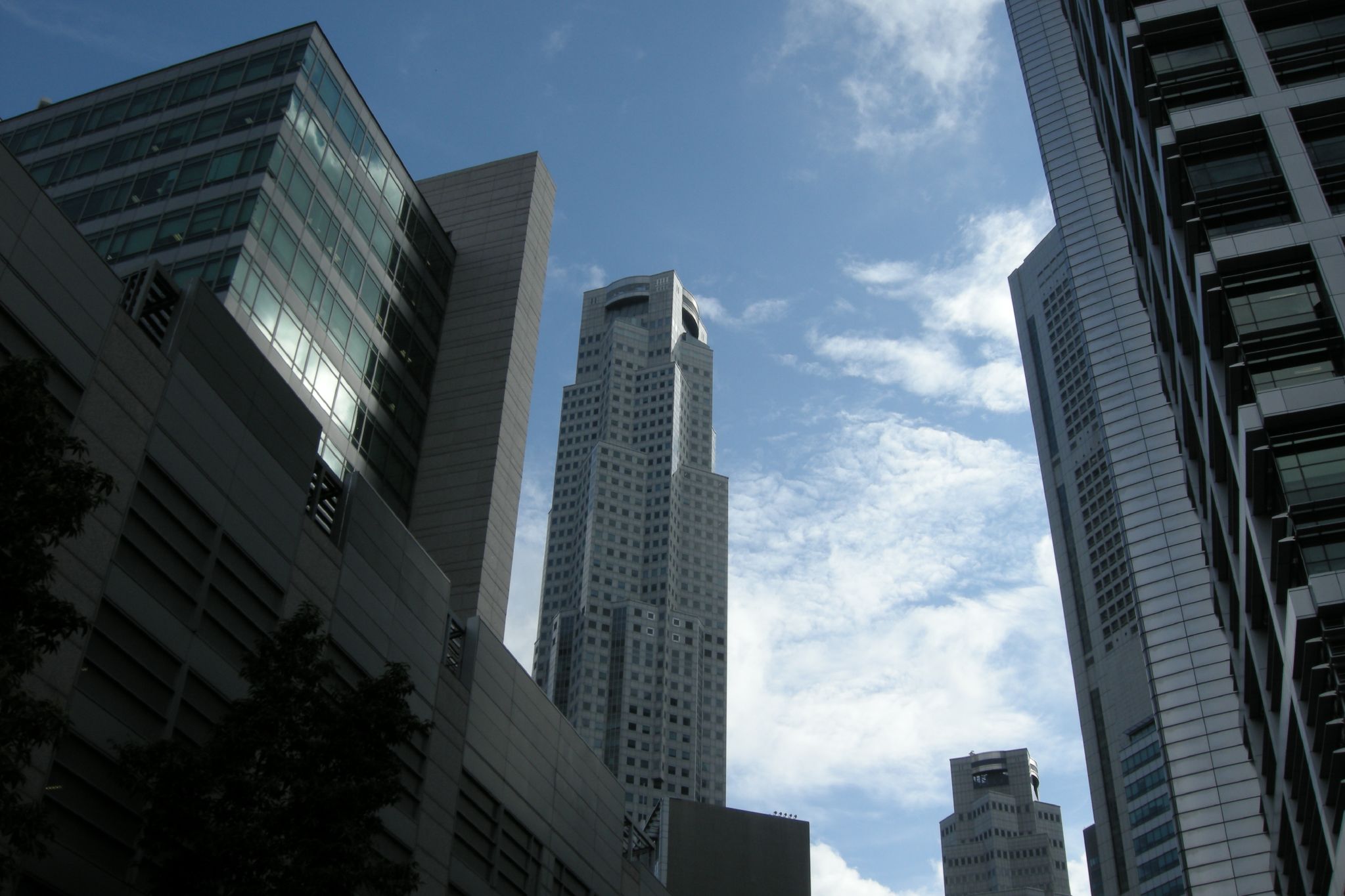 some very tall buildings with blue sky in the background