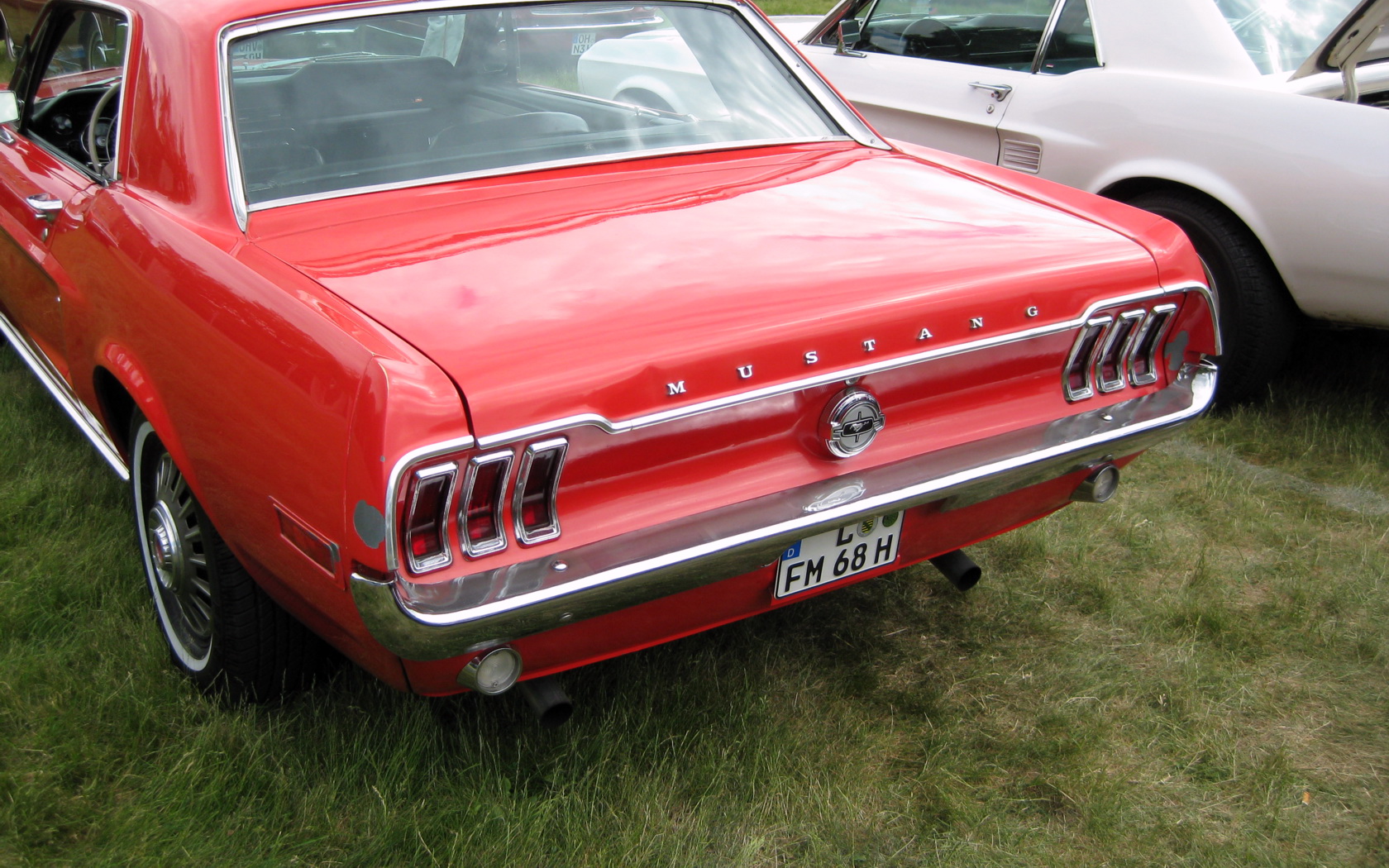 this red ford mustang coupe has the company's initials on the hood