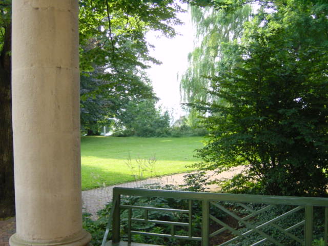 a large stone column and two white pillars