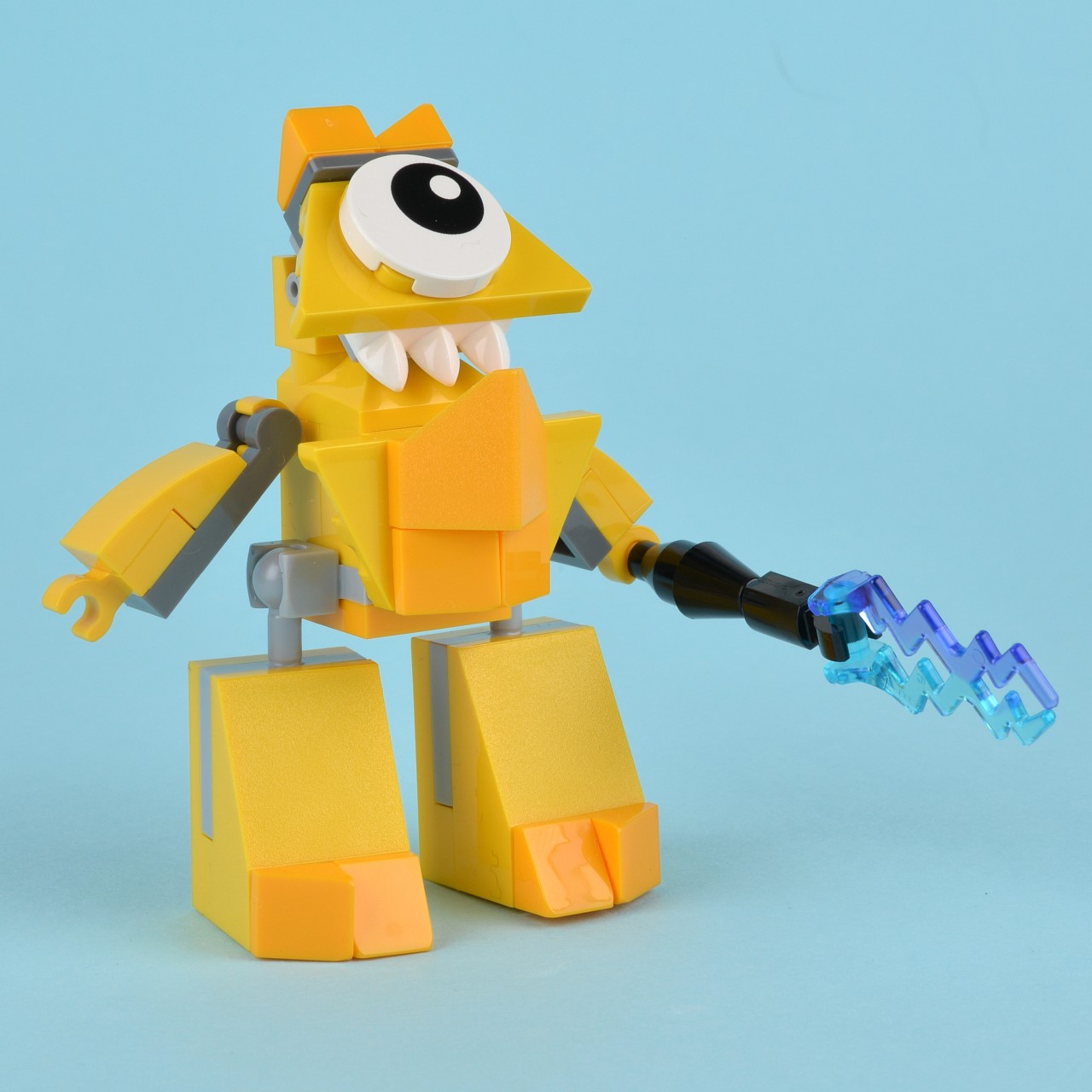 yellow lego robot with sharp blade and eye patch