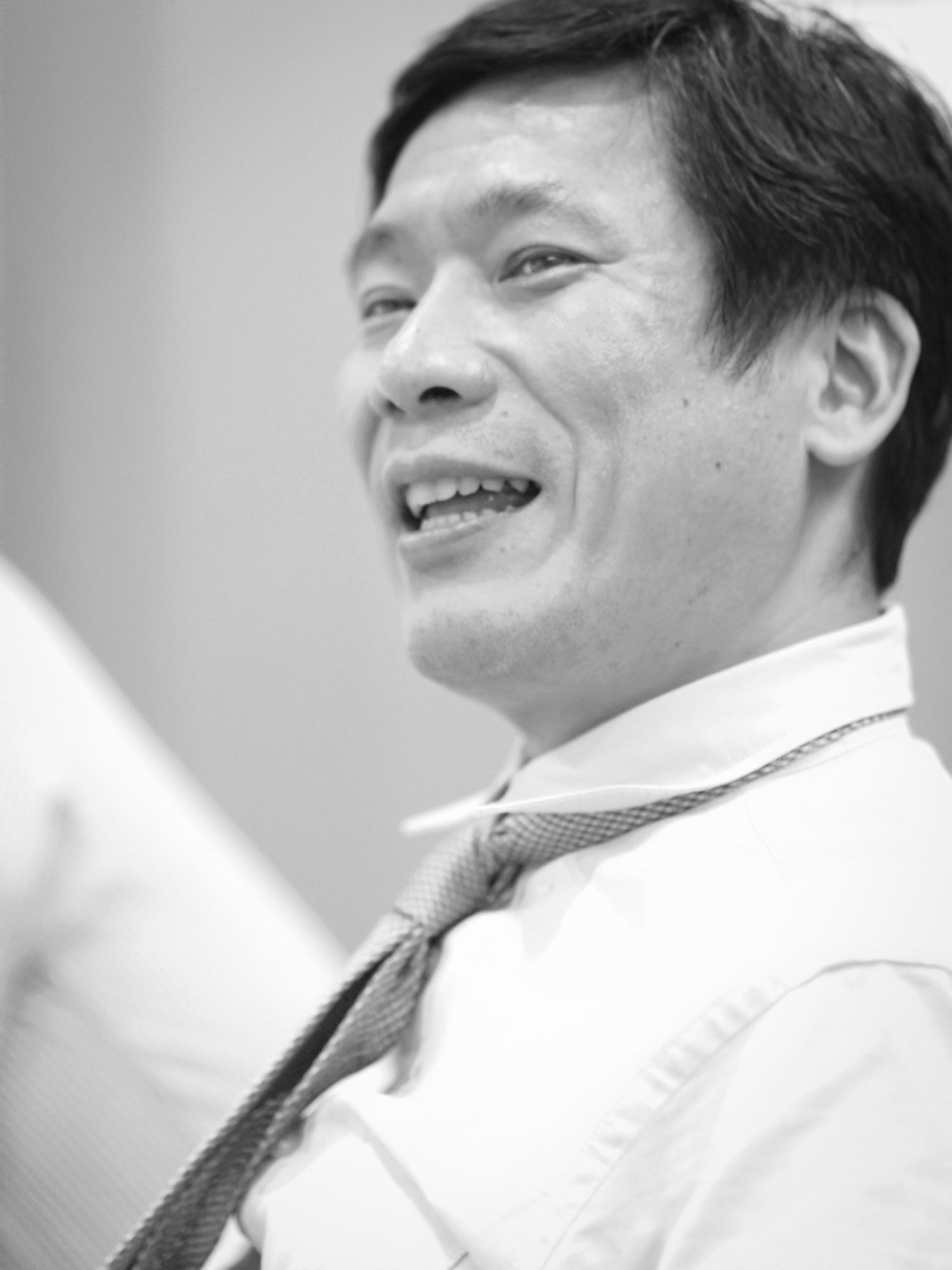 black and white pograph of a man wearing a tie