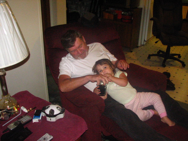 a man is sitting in the chair with a small girl