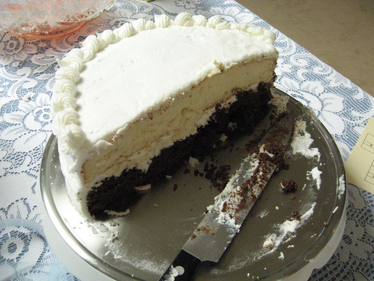 there is a large cake with white frosting on a plate