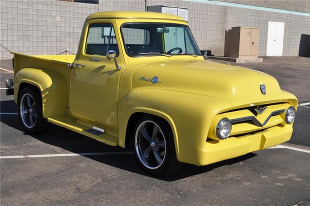 a yellow truck with chrome hood parked in a parking lot