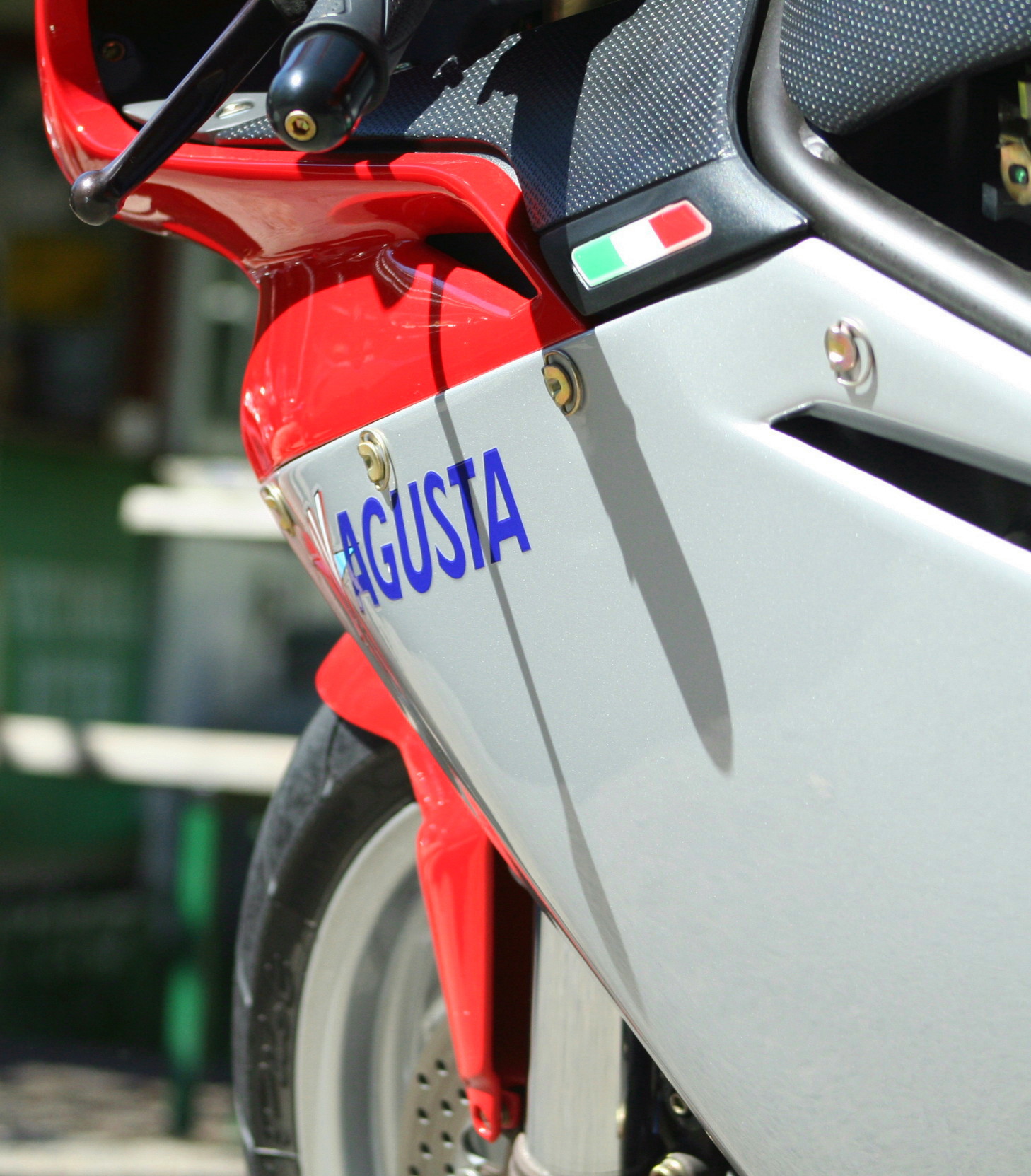 a close up view of the emblem on a red and silver motor bike