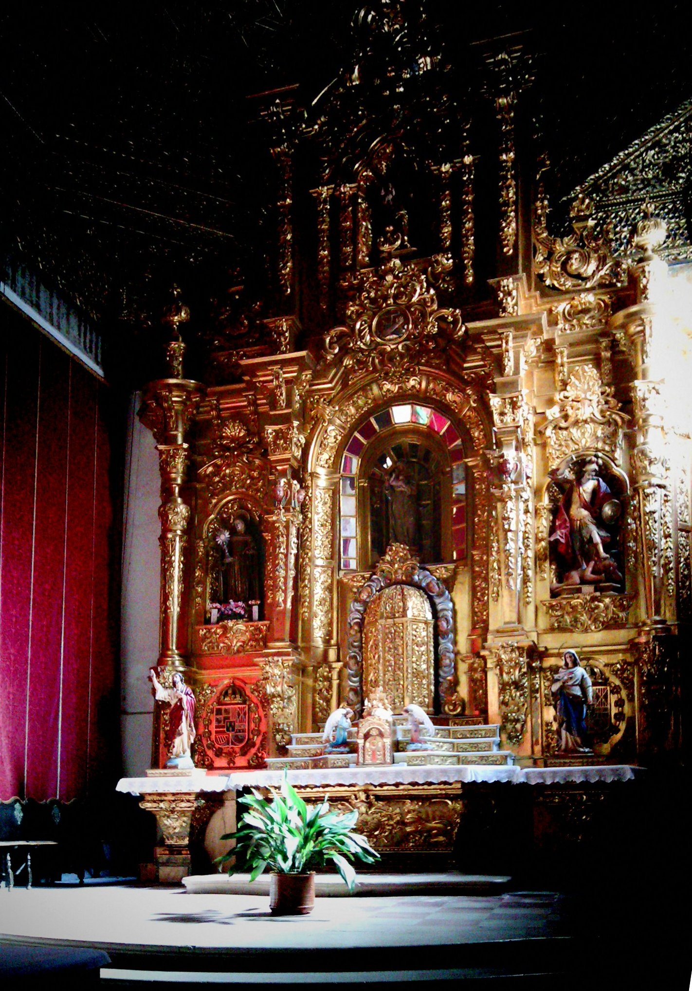 an elaborate gold alter in front of a stage with people
