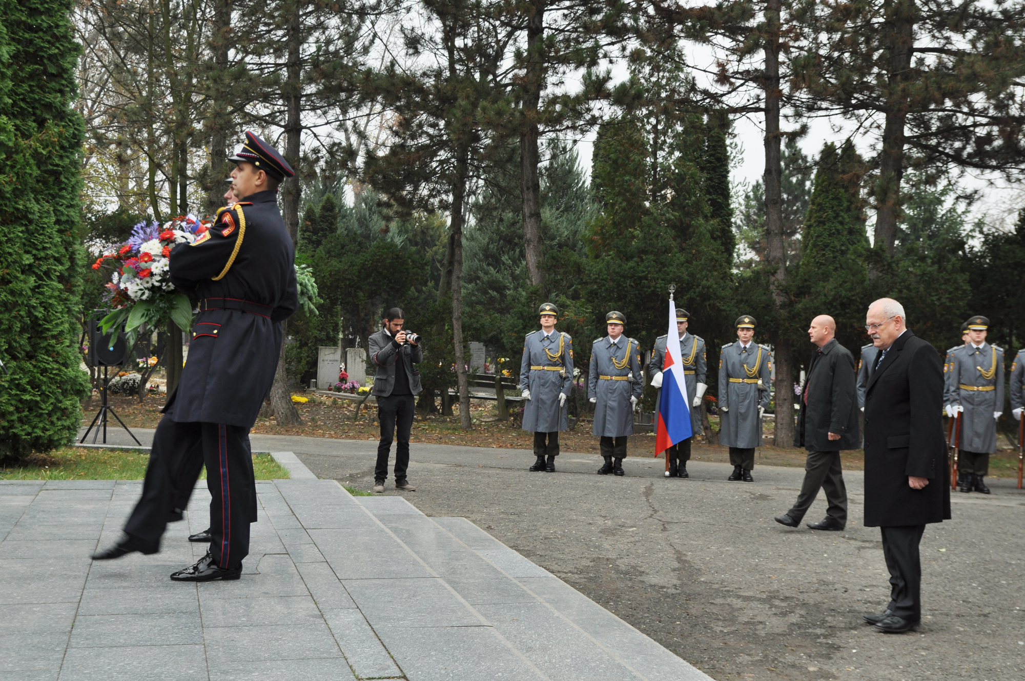 military officers are in formal dress and flags