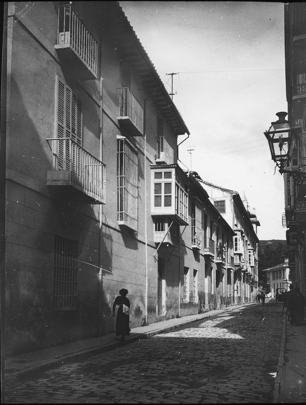 a black and white image of a street in an old city