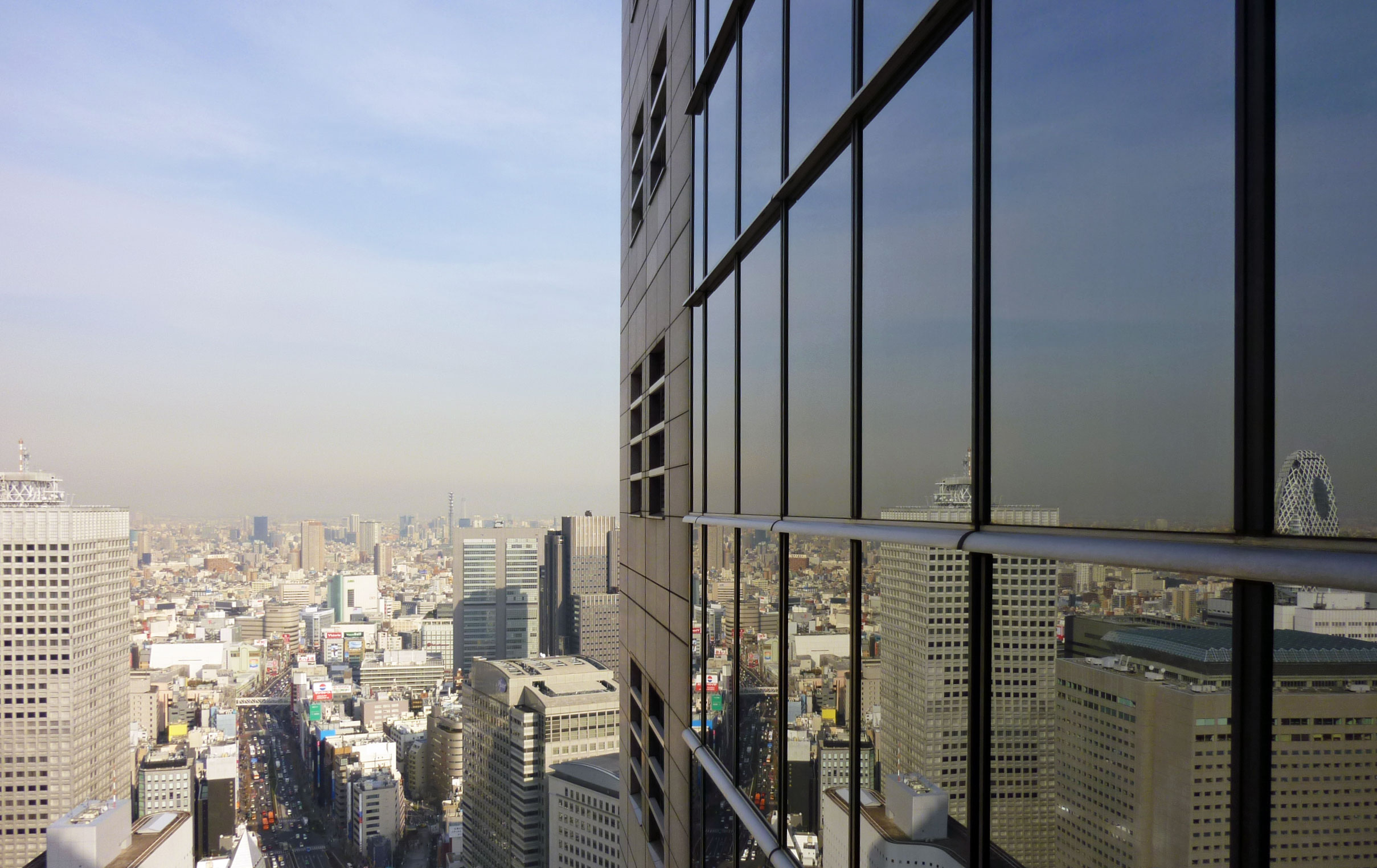 large glass windows stand in front of city skyscrs