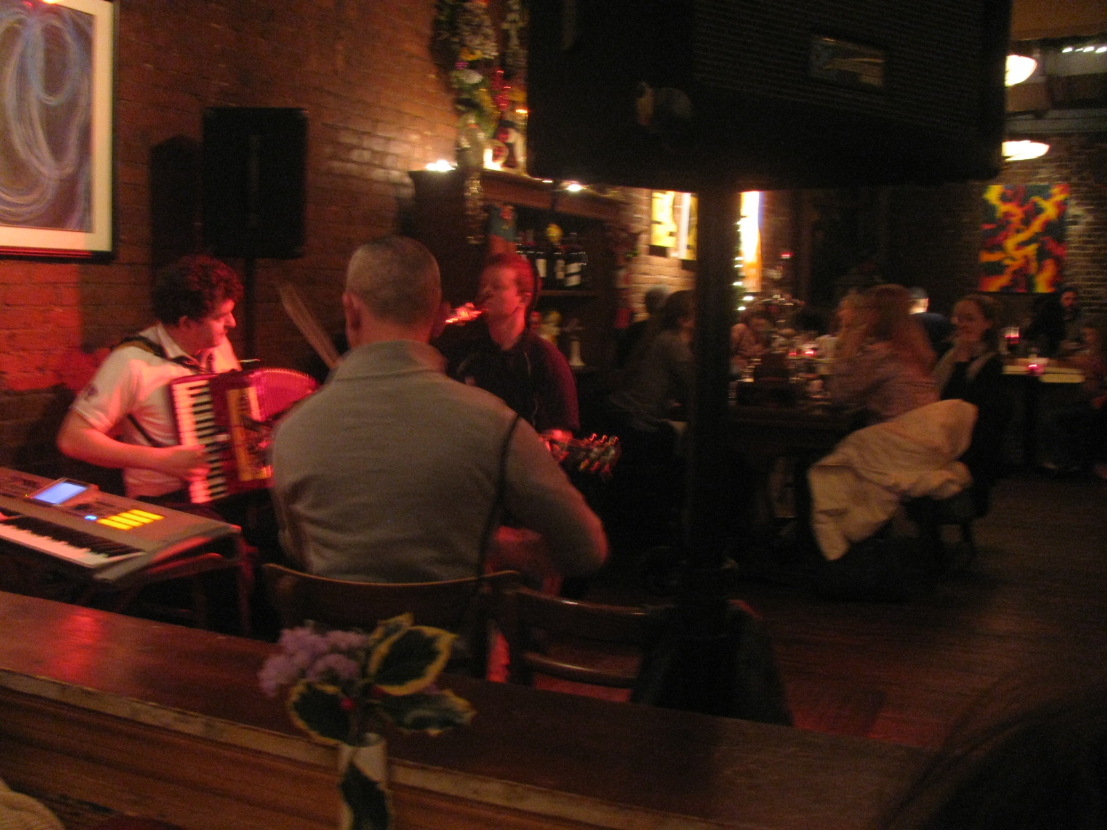 a group of people sitting around a table playing instruments