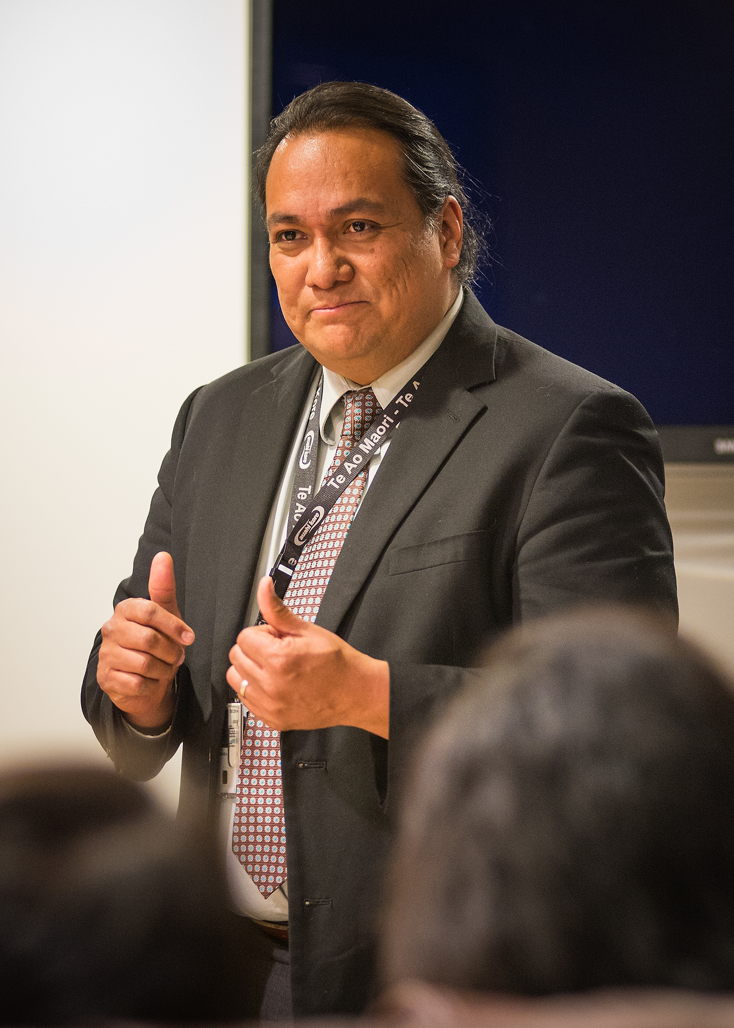 a man in a suit giving a talk