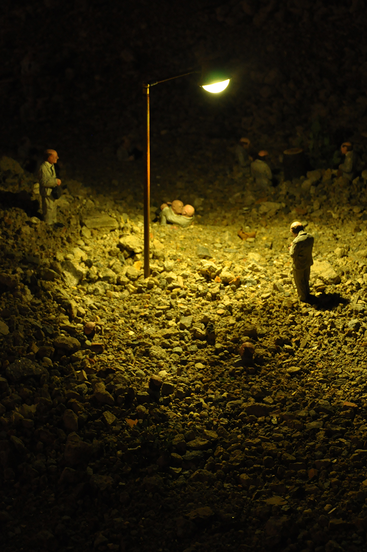 the lights are on while people stand around a dirt area