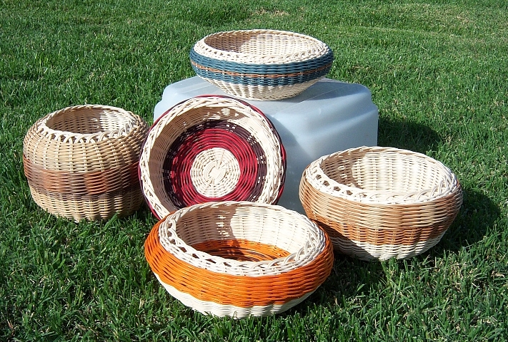 this po shows a bunch of wicker bowls on the grass