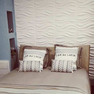 the bedroom features white waves on the wall behind the bed