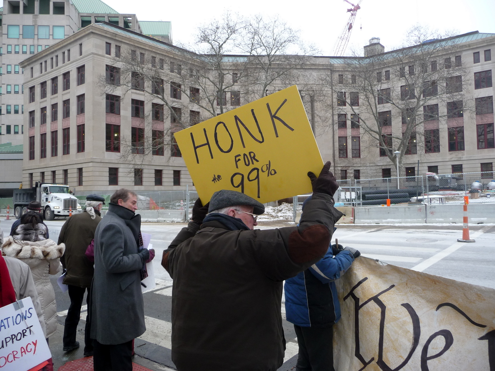 a protestor holds up a sign for obama