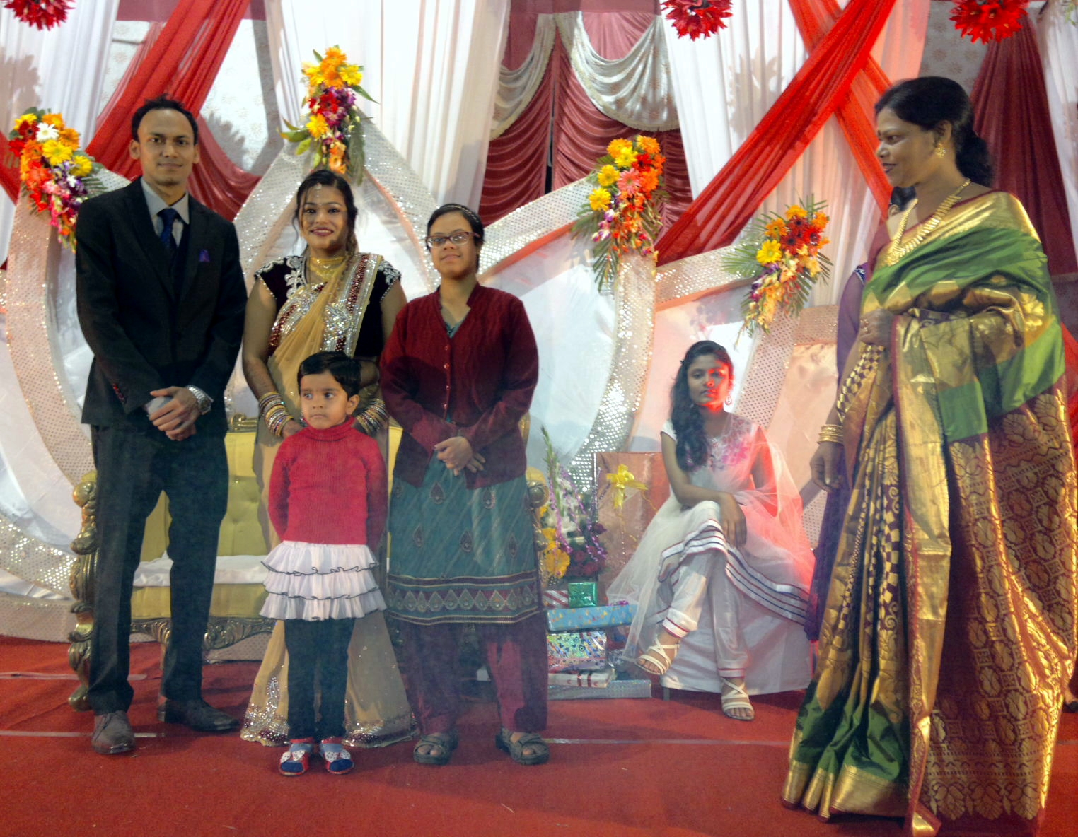 people posing for a po in a wedding ceremony