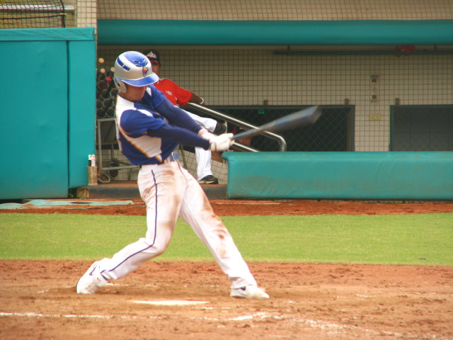 the baseball player is hitting the ball
